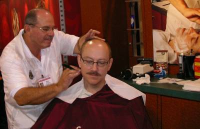 Mario Herrera of V's Barbershop looks for some hair to shave